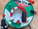 a close up of a green and red hose on a metal stand