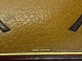 brown and black purse with a bow on the front of it