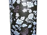 a black vase with white and purple flowers on it