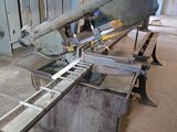 a picture of a large metal cutting machine in a building