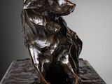 bronze sculpture of a wolf on a marble base