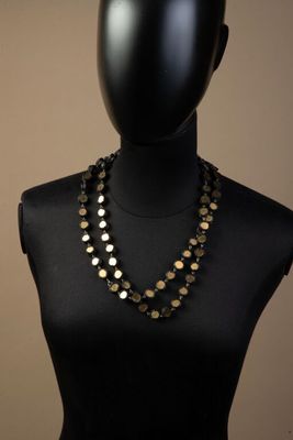a close up of a mannequin torso with a necklace on it