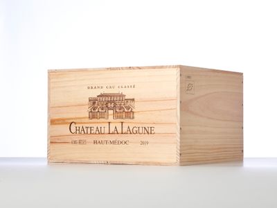 the wooden box is holding a bottle of wine on the table