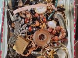 a box full of assorted jewelry on a table