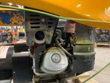 a close up of the engine of a yellow tractor