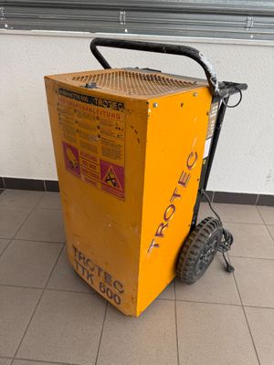 a cart that is sitting on the floor next to a wall