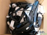 a cardboard box filled with a bunch of different types of belts
