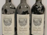 three bottles of wine sitting on top of a white table