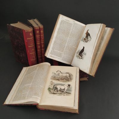 several old books sitting on top of a table next to each other