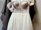 a dress hanging on a hanger on a wall