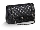 un sac Chanel noir avec une bandoulière en chaîne sur fond blanc