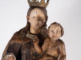 an old statue of a woman holding a child with a crown on her head