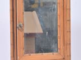 a small wooden cabinet with a mirror on top of it