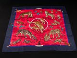 an image of a red and blue scarf with tigers on it