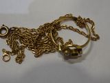 a gold chain with a skull charm on it