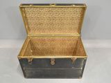 a black and gold trunk with a gold handle