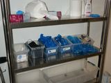 a metal shelving with plastic containers on top of it