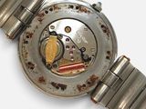 a close up of a watch on a white surface