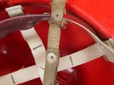 a close up of a red fire helmet with a wooden stick sticking out of it