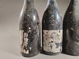 three bottles of wine sitting next to each other on a table