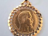 a close up of a gold coin with a woman ' s face on it