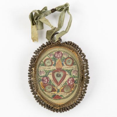 a close up of a necklace with a ribbon on a white background