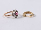 two gold rings with diamonds and a pink sapphire