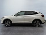 the rear view of a white suv parked in a room