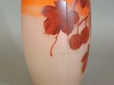 a vase with a leaf design on it on a table