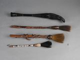 three different types of brooms and a brush on a table