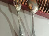 two forks and spoons sitting on a table