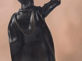 a statue of a man holding a bird in his hand