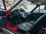 a red car with black leather seats and a steering wheel