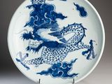 blue and white porcelain plate with a dragon on it