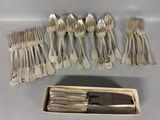 a lot of forks and spoons that are in a box