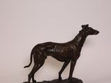 statue of a greyhound dog on a marble base on a white background