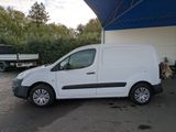 a white van parked in front of a building