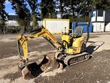 a small excavator that is sitting in the dirt