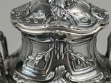 a silver plate with a silver lid on it