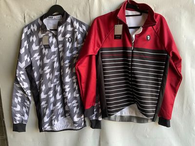 two men ' s jackets hanging on a clothes rack on a wall