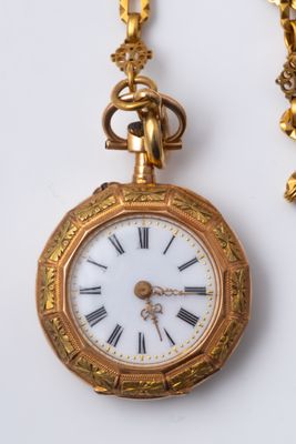 a gold pocket watch with roman numerals on it