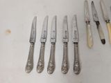 several knives are lined up next to each other on a table