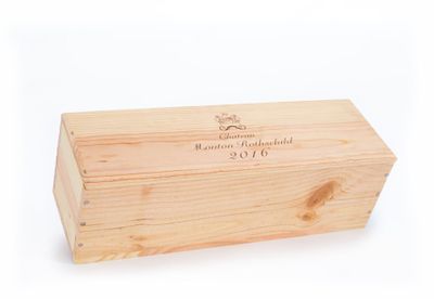 a wooden box with a label on it sitting on a white surface