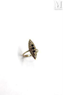 a close up of a gold ring with black stones on it