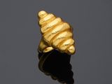 a gold ring sitting on top of a black surface