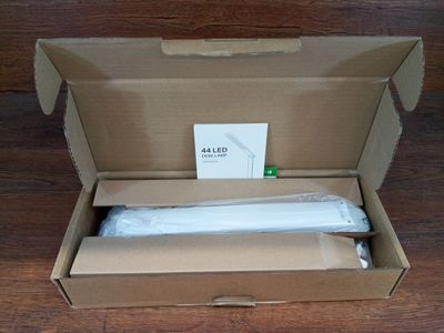 packaging of a box with a white cloth inside of it on a wooden floor