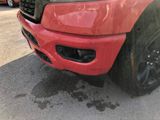 a close up of a red truck parked in a parking lot