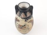 a black and white vase with a painting on it