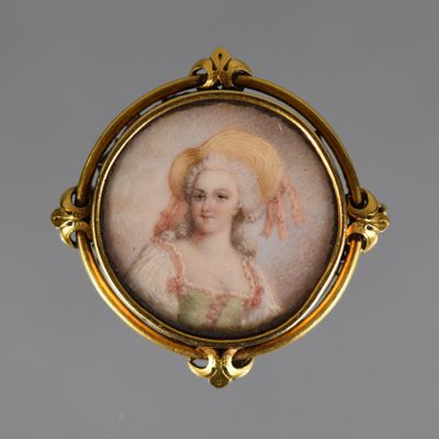 portrait of a woman in a bonnet in a gold broochle