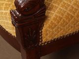 a chair that has a yellow upholstered cushion on it